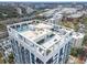 Aerial view showcasing the building's rooftop amenities, including a pool, seating areas, and lush landscaping at 260 S Osceola Ave # 601, Orlando, FL 32801