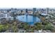 Breathtaking aerial view showcasing a serene lake surrounded by lush greenery and a vibrant cityscape skyline at 260 S Osceola Ave # 601, Orlando, FL 32801