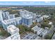 Aerial view of multiple mid-rise buildings, lush green landscaping, and a parking lot at 260 S Osceola Ave # 601, Orlando, FL 32801