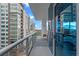 Wide shot of a balcony with railings, a chair, and a cityscape view at 260 S Osceola Ave # 601, Orlando, FL 32801