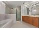 Luxurious bathroom with double sinks, a glass shower, a chandelier and a soaking tub at 260 S Osceola Ave # 601, Orlando, FL 32801