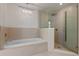 Bright bathroom featuring a soaking tub and glass-enclosed shower at 260 S Osceola Ave # 601, Orlando, FL 32801