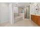 Elegant bathroom featuring a soaking tub, glass-enclosed shower, and double vanity at 260 S Osceola Ave # 601, Orlando, FL 32801