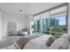 Bright bedroom with sleek furniture, pendant lighting, and cityscape views at 260 S Osceola Ave # 601, Orlando, FL 32801