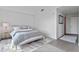Modern bedroom with neutral tones and a sleek design, adjacent to an art-filled hallway at 260 S Osceola Ave # 601, Orlando, FL 32801