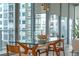 Bright dining area with wood table and floor-to-ceiling windows offering city views at 260 S Osceola Ave # 601, Orlando, FL 32801