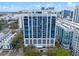 Stunning exterior view of a modern high-rise condo building with blue windows in an urban setting at 260 S Osceola Ave # 601, Orlando, FL 32801