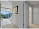 Bright hallway leading to a bedroom, featuring tile floors and a fluffy rug at 260 S Osceola Ave # 601, Orlando, FL 32801