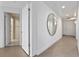 Bright hallway featuring light colored walls, tile floors, and a circular mirror at 260 S Osceola Ave # 601, Orlando, FL 32801