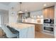 Modern kitchen with stainless steel appliances, quartz countertops, and breakfast bar at 260 S Osceola Ave # 601, Orlando, FL 32801