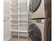Organized laundry area with shelving and a stacked washer and dryer at 260 S Osceola Ave # 601, Orlando, FL 32801