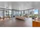 Sun-drenched living area with sleek tile flooring, floor-to-ceiling windows, and modern furnishings at 260 S Osceola Ave # 601, Orlando, FL 32801