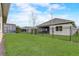 Lush backyard boasts manicured lawn, screened-in lanai, and secure fencing at 2741 Southland St, St Cloud, FL 34772