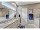 Bathroom has a double vanity with granite countertop, modern fixtures, a large mirror and a separate shower at 2741 Southland St, St Cloud, FL 34772