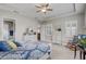 Relaxing bedroom boasts a ceiling fan, shuttered windows and views through to the ensuite bathroom at 2741 Southland St, St Cloud, FL 34772