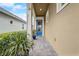 Charming home with a vibrant blue front door, tiled walkway, and lush plants at 2741 Southland St, St Cloud, FL 34772