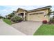 Street view of an inviting home featuring an attached two car garage and a manicured front lawn at 2741 Southland St, St Cloud, FL 34772
