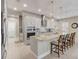 A modern kitchen with stainless steel appliances, granite countertops, and pendant lighting over a large island with seating at 2741 Southland St, St Cloud, FL 34772