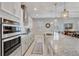 Bright kitchen boasts stainless steel appliances, stylish countertops, tile backsplash, and an island with barstool seating at 2741 Southland St, St Cloud, FL 34772