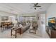 Comfortable living room featuring neutral tones, a ceiling fan, and an adjacent dining area at 2741 Southland St, St Cloud, FL 34772