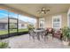 A covered patio has brick pavers, a ceiling fan, and an outdoor dining set at 2741 Southland St, St Cloud, FL 34772