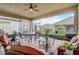 The screened lanai features a ceiling fan, comfortable seating, and brick pavers at 2741 Southland St, St Cloud, FL 34772