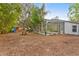 Large backyard with a wooden playset, picnic table, screened-in pool, mature trees and wood fencing at 2856 Broward Ct, Oviedo, FL 32765