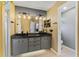 A bathroom featuring double sinks, updated lighting, and a separate toilet area at 2856 Broward Ct, Oviedo, FL 32765