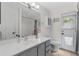 Bright bathroom with a white vanity, enclosed shower, and outdoor access at 2856 Broward Ct, Oviedo, FL 32765