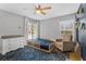 A bedroom featuring a ceiling fan, modern dresser and a large window at 2856 Broward Ct, Oviedo, FL 32765