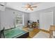 A well-lit bedroom featuring a ceiling fan, closet, and light grey walls at 2856 Broward Ct, Oviedo, FL 32765
