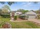 Charming single-story home featuring a well-manicured lawn, stone accents, and a red front door at 2856 Broward Ct, Oviedo, FL 32765