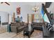 Spacious living room with cozy seating, fireplace, and natural light from large windows at 2856 Broward Ct, Oviedo, FL 32765