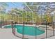 Sparkling screened-in pool and spa area with black safety fence and lush landscaping at 2856 Broward Ct, Oviedo, FL 32765