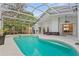 A screened-in pool area featuring a pool, spa, and outdoor seating area at 2856 Broward Ct, Oviedo, FL 32765