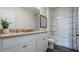 This modern bathroom has dual sinks, white cabinets, quartz countertops and stylish fixtures at 3017 Moulin Rd, Davenport, FL 33837