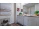 The bathroom features a double vanity with framed mirrors and modern fixtures at 3017 Moulin Rd, Davenport, FL 33837