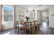 Bright dining area with a farmhouse-style table and a view of the outdoors through large windows at 3017 Moulin Rd, Davenport, FL 33837