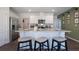 Modern kitchen with white cabinets, stainless steel appliances, and a spacious island with seating at 3017 Moulin Rd, Davenport, FL 33837
