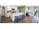 An open-concept kitchen boasts modern appliances, a central island with seating, and seamless flow to the living area at 3017 Moulin Rd, Davenport, FL 33837
