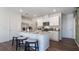 This bright, modern eat-in kitchen features white cabinets, stainless appliances, and bar seating at 3017 Moulin Rd, Davenport, FL 33837