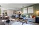 Spacious living room with an open layout, comfortable seating, and a view of the modern kitchen at 3017 Moulin Rd, Davenport, FL 33837