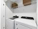 Laundry room features front load washer and dryer with wire shelving at 3199 Emerald Acres Ln, Sanford, FL 32771