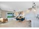 Open floor plan living area featuring a large dining table, contemporary decor, and access to the backyard at 3199 Emerald Acres Ln, Sanford, FL 32771