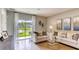 Cozy living room bathed in natural light through a sliding glass door with view of green space at 3621 Salvia Ct, Tavares, FL 32778
