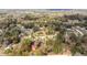 Expansive aerial view of a rural neighborhood with houses interspersed among dense trees at 3742 Se 131St Pl, Belleview, FL 34420