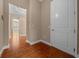 Hallway showcasing hardwood floors, neutral walls, and natural light filtering through windows at the end of the hall at 3863 Nw 49Th Ct, Ocala, FL 34482