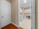 View into the laundry room featuring a washer/dryer, desk, and cabinets from a doorway with hardwood floors at 3863 Nw 49Th Ct, Ocala, FL 34482