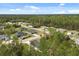 Expansive aerial view of the neighborhood showcasing the single Gathering homes surrounded by lush greenery at 3995 Sw 151 Street, Ocala, FL 34473