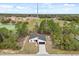 An aerial view of a modern single-story home highlights its architecture and setting in a naturally landscaped environment at 3995 Sw 151 Street, Ocala, FL 34473